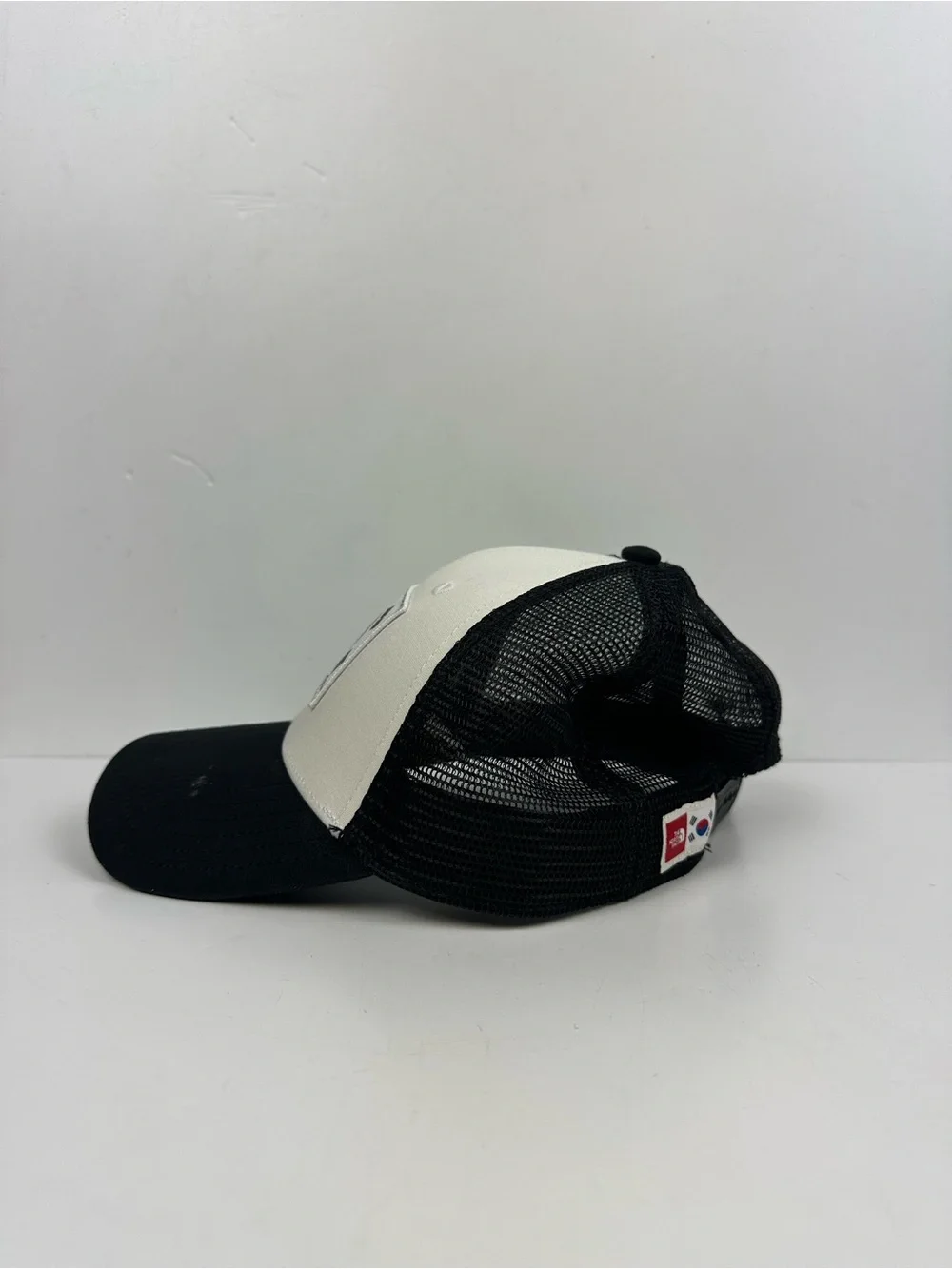The North Face Black & White Trucker Hat with South Korea Flag Patch